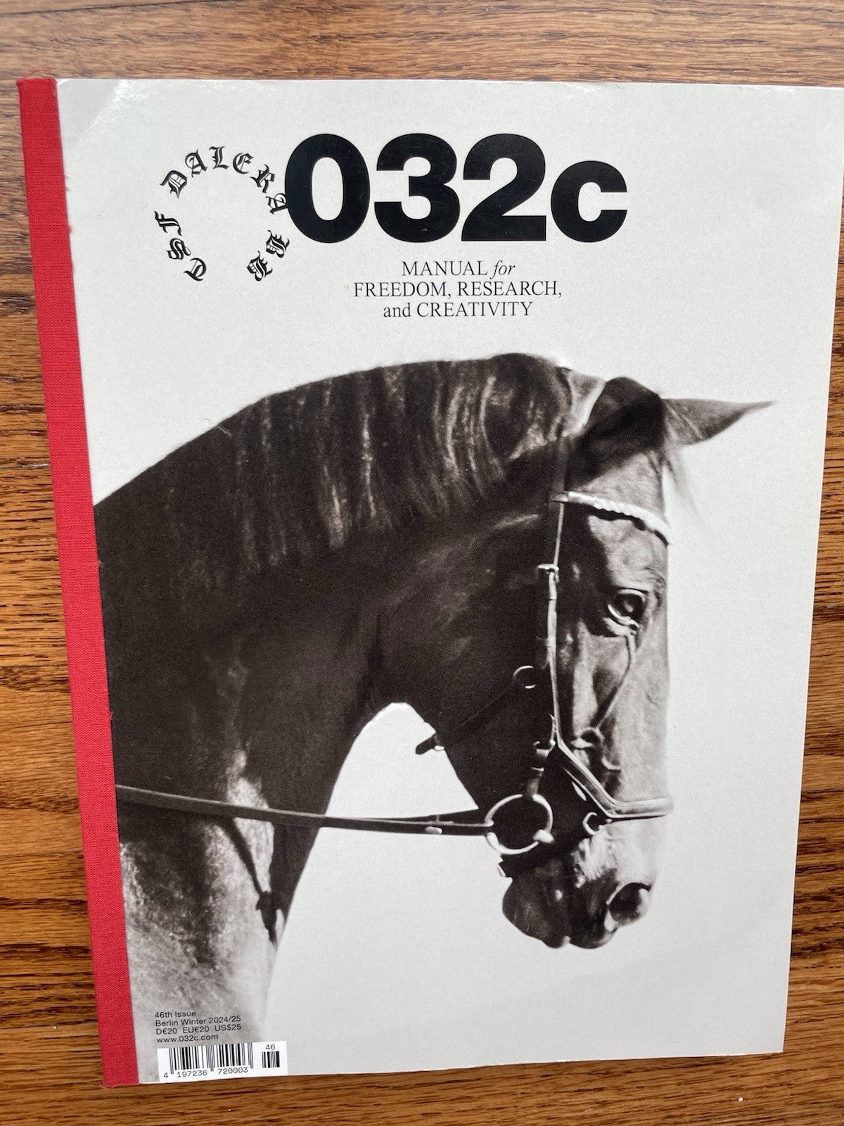 032c magazine issue 46 cover, close-up of a bridled horse's head against a plain background, red spine binding