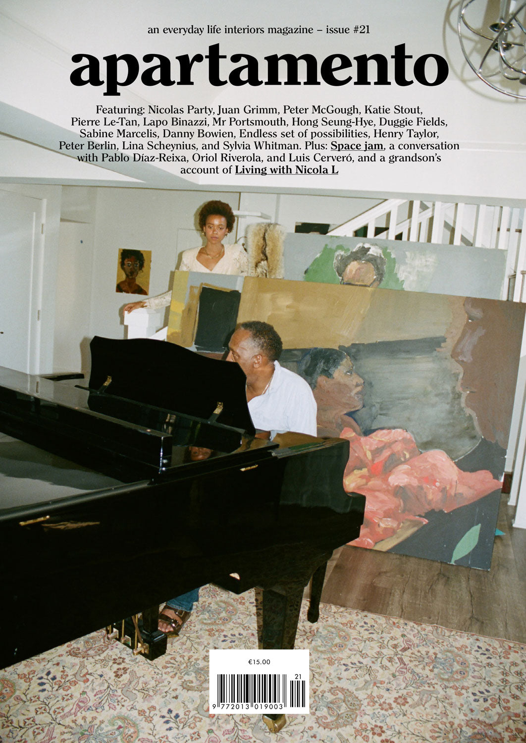 Apartamento magazine issue 21 cover, man playing piano beside a large abstract painting